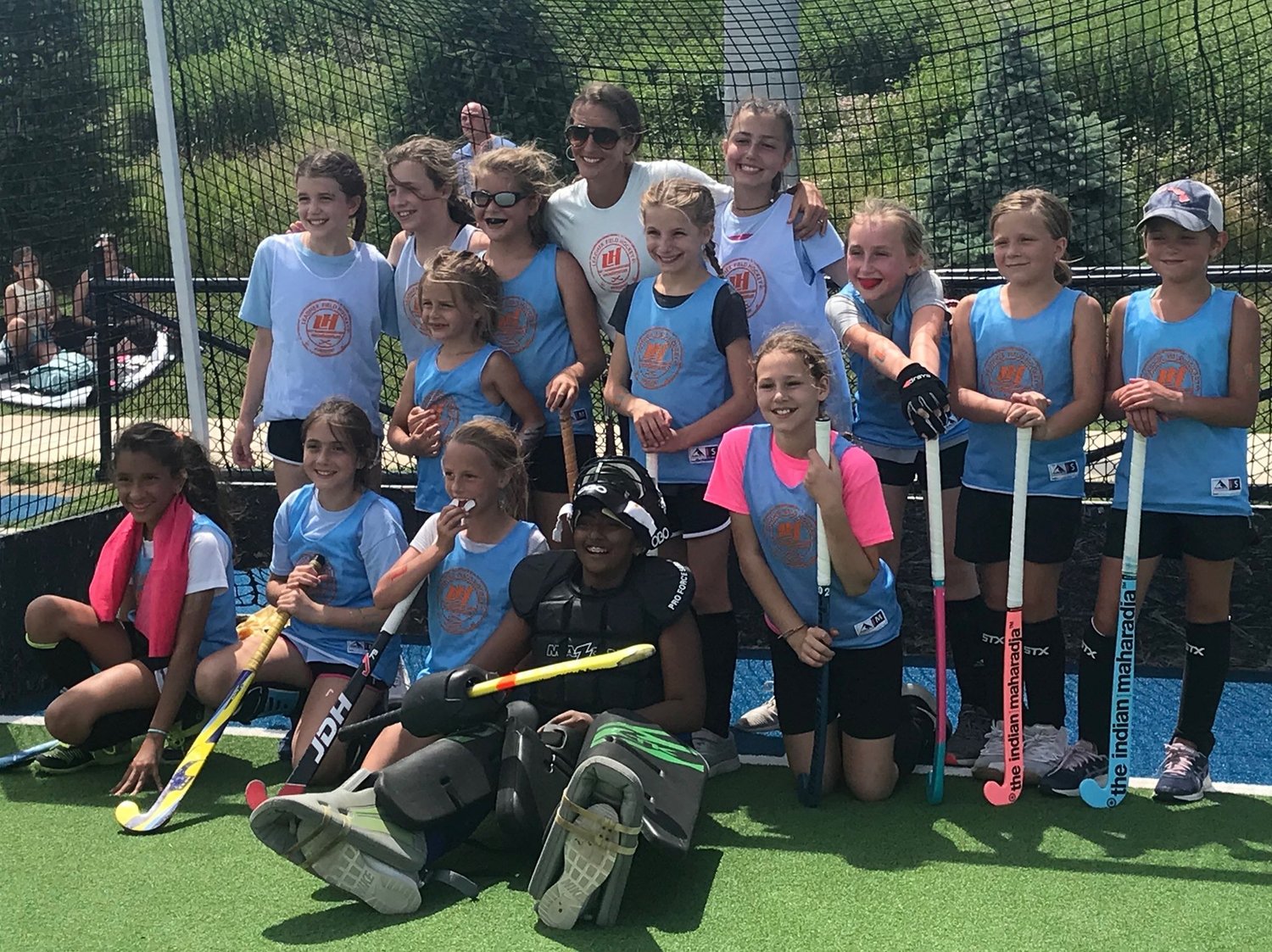 Melisa with LeadHer field hockey players on the training turf